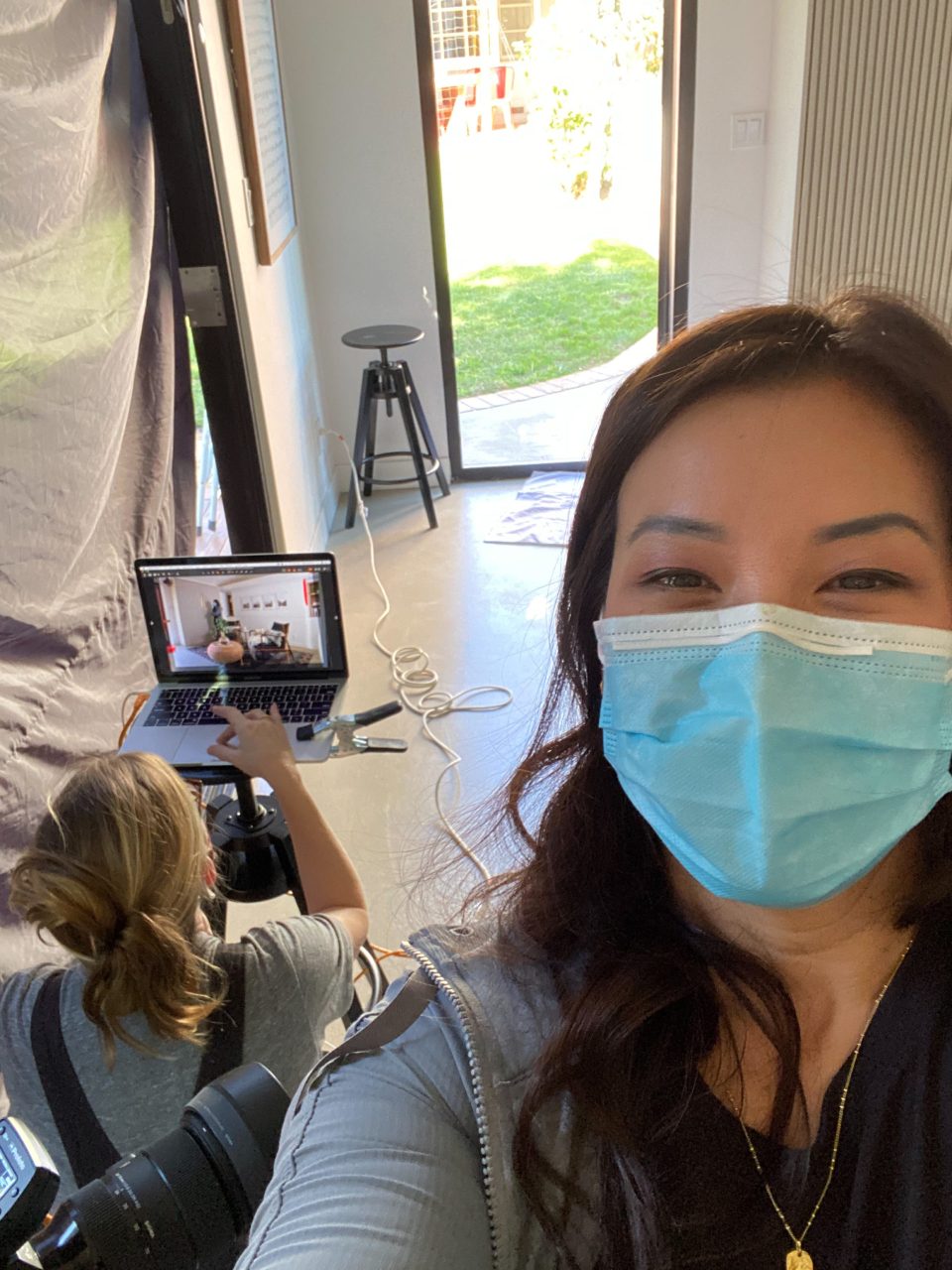 Anita in a mask at an in-home photo shoot