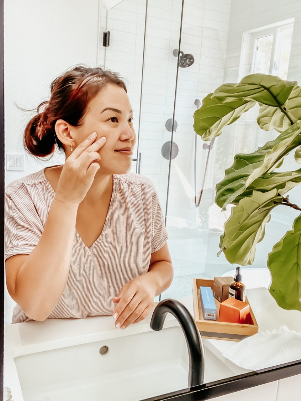 Anita at the mirror, touching her face