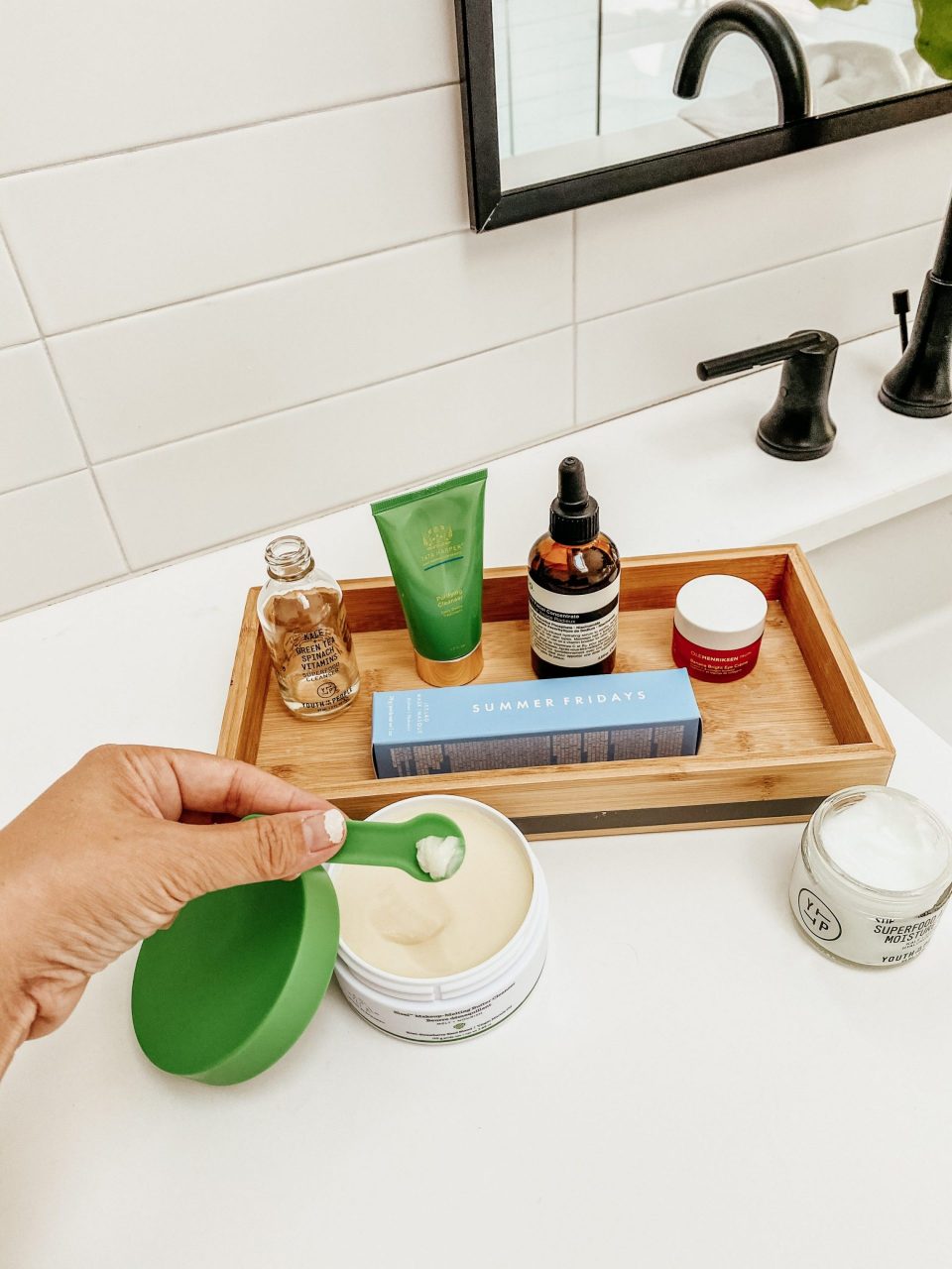 Anita's hand dipping into her product tray