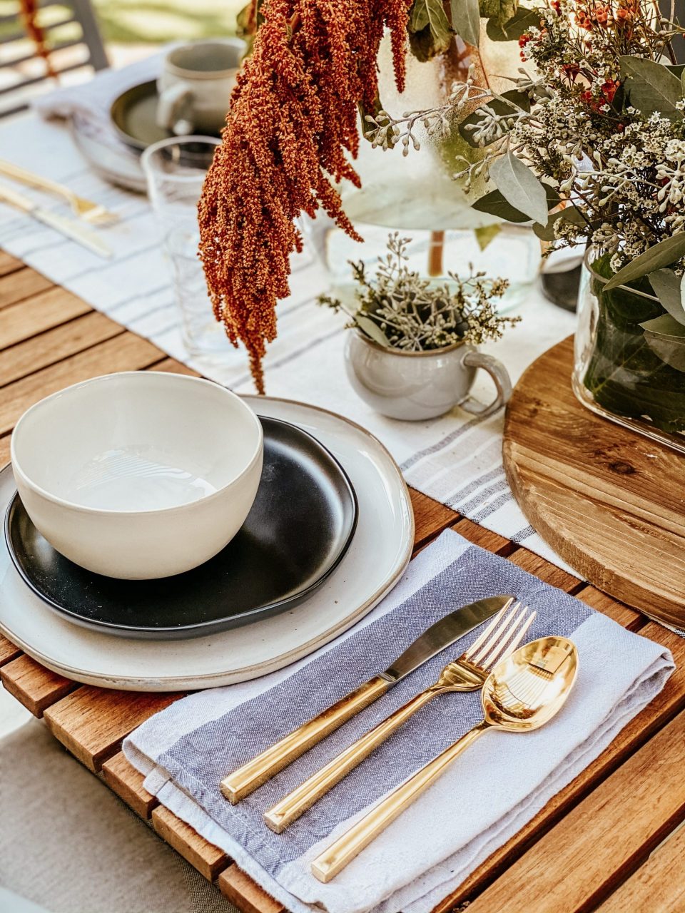 Gold Flatware set next to ceramic table setting