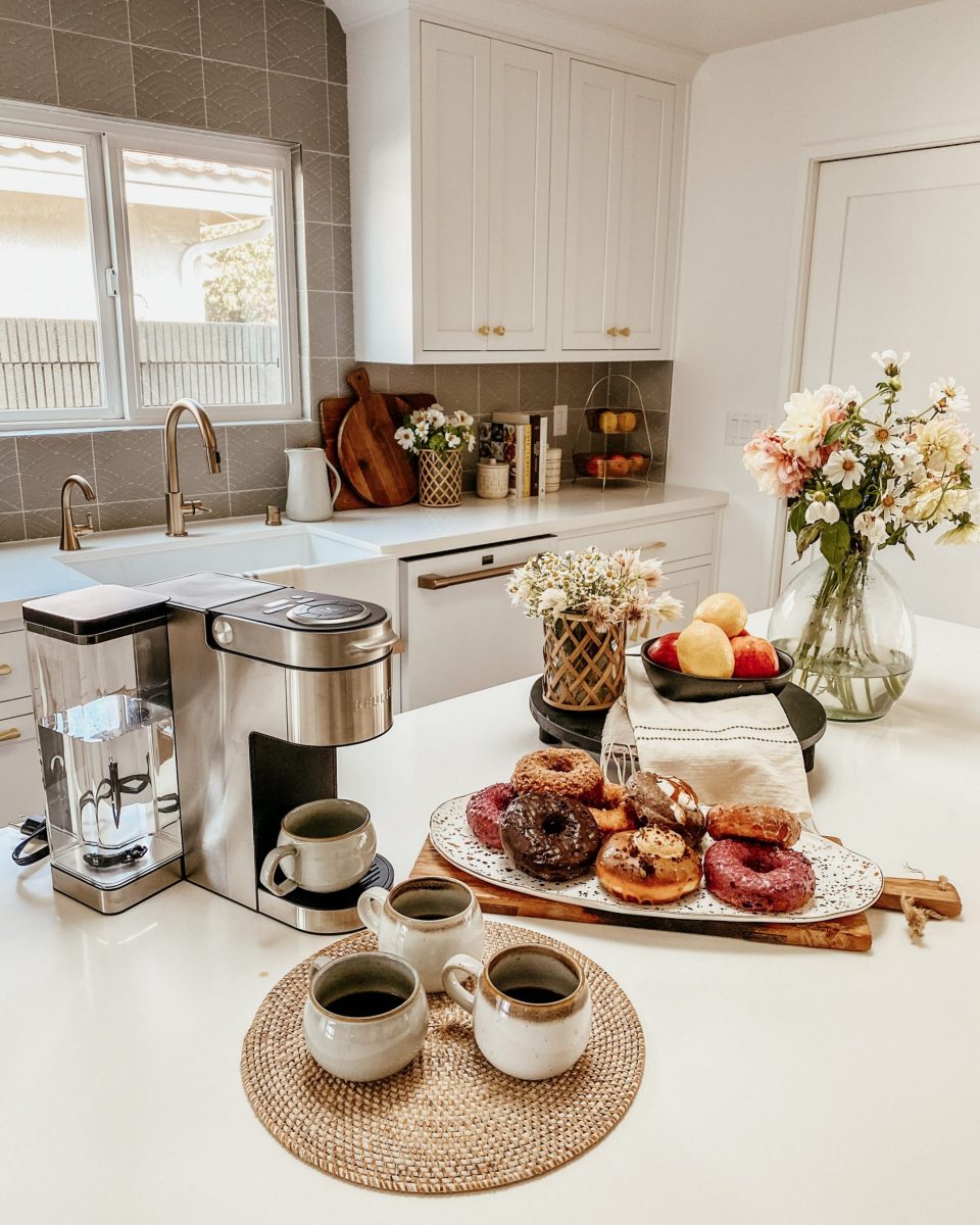 coffee and donut spread on a clean, white, modern counter