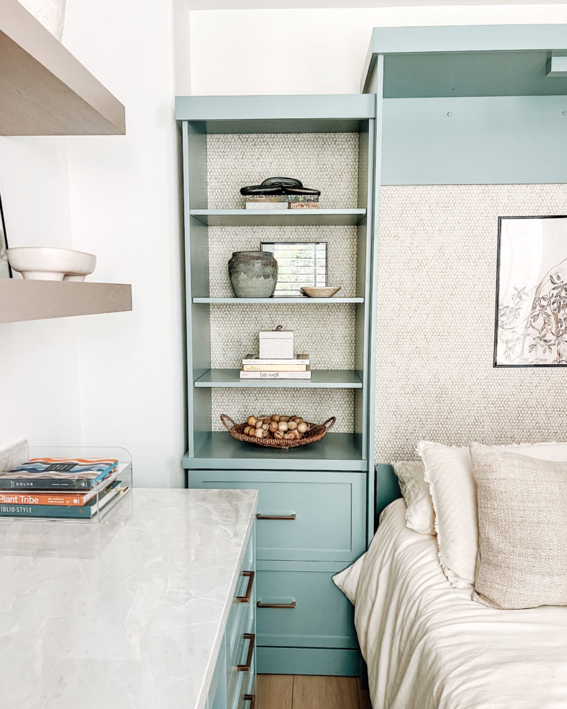 the wallpaper detail behind the murphy bed's shelving system