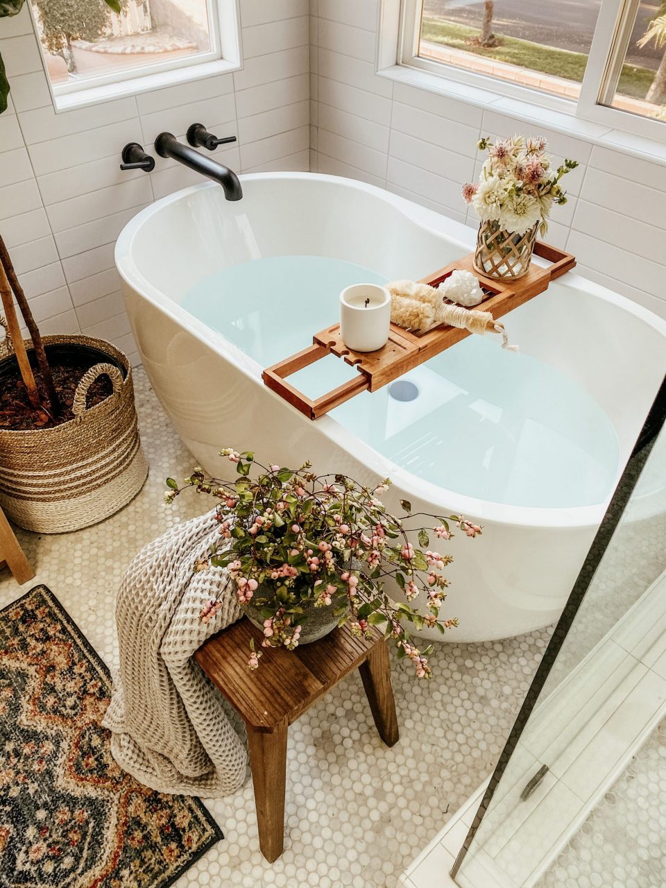 A relaxing bath drawn, complete with floral bouquet