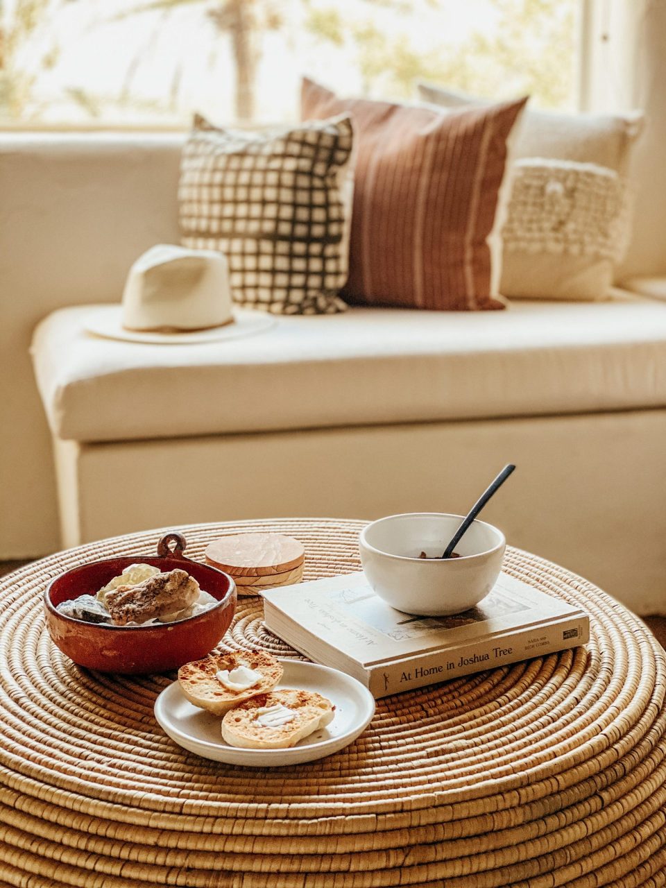 healthy, wholesome breakfast laid out on a wicker ottoman