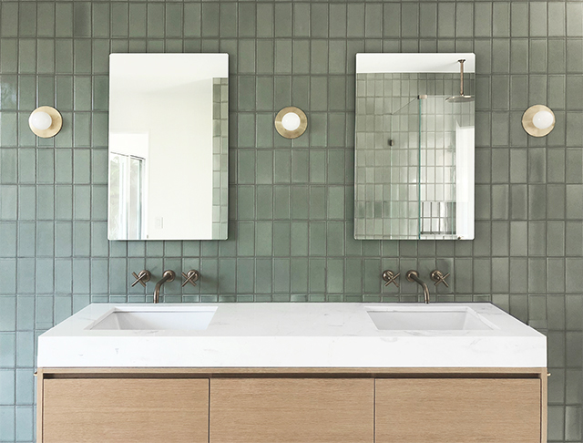 Green tiled wall behind the Jack & Jill sink