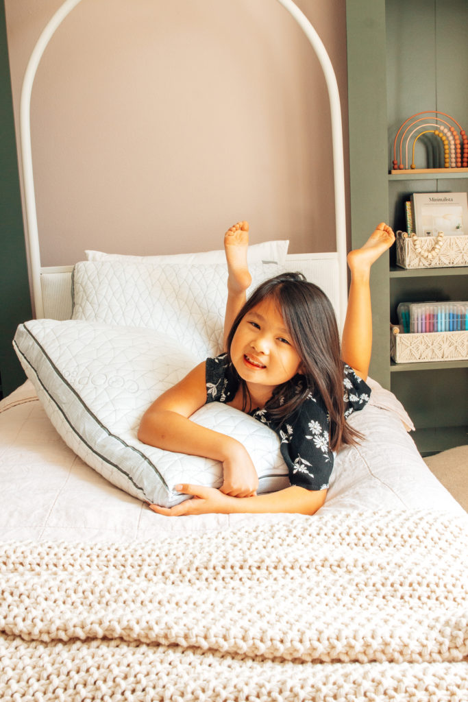 Natalie, laying on her new bed in this modern fairy tale space!