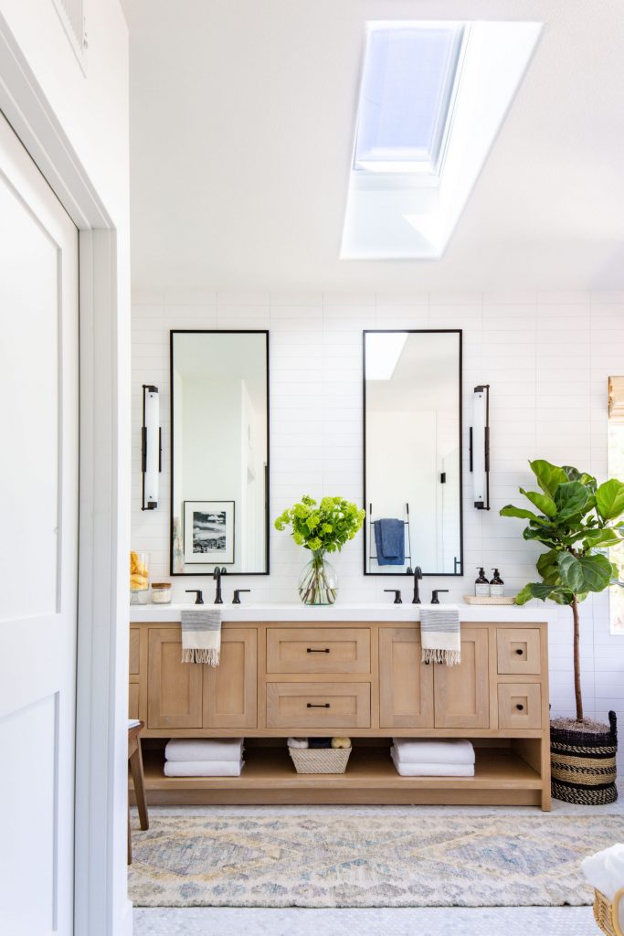 master bathroom Velux skylight black pendant free standing tub white oak vanity 
