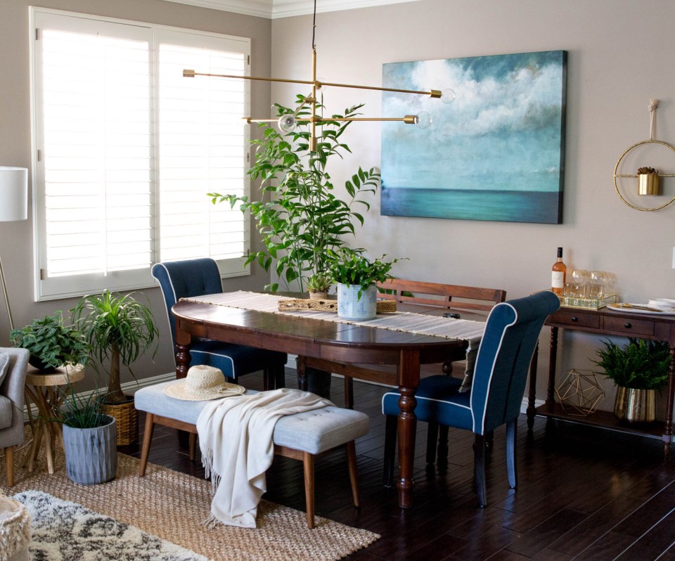 Dark wood dining area, adjacent to grey couch seating area